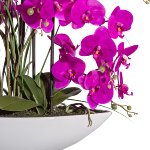 Artificial plant orchid in white ceramic bowl